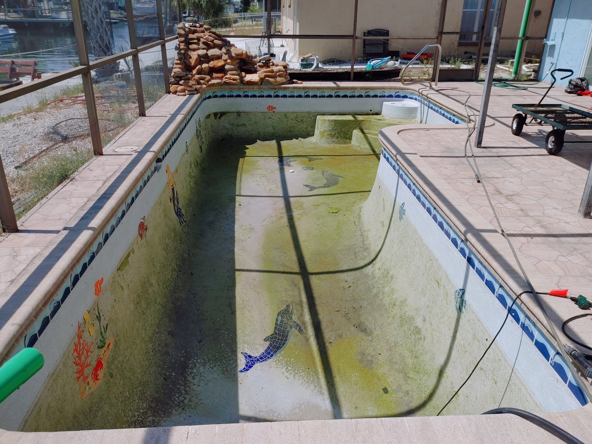 The same pool with a stained and worn surface before restoration